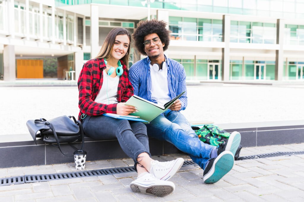 students siting in front of the university